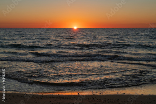 Fototapeta Naklejka Na Ścianę i Meble -  Incoming wave and setting sun over the Baltic Sea, Curonian Spit, Kaliningrad region, Russia