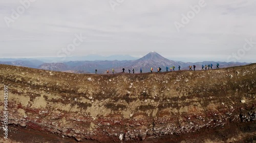 People walk along the top of the volcano, Gorely volcano, Kamchatka