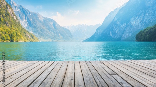 Fototapeta Naklejka Na Ścianę i Meble -  A tranquil mountain lake awaits visitors, featuring a spacious wooden deck that invites relaxation while surrounded by stunning mountains