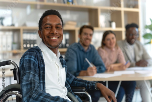 Empowered African American man in wheelchair smiling with colleagues