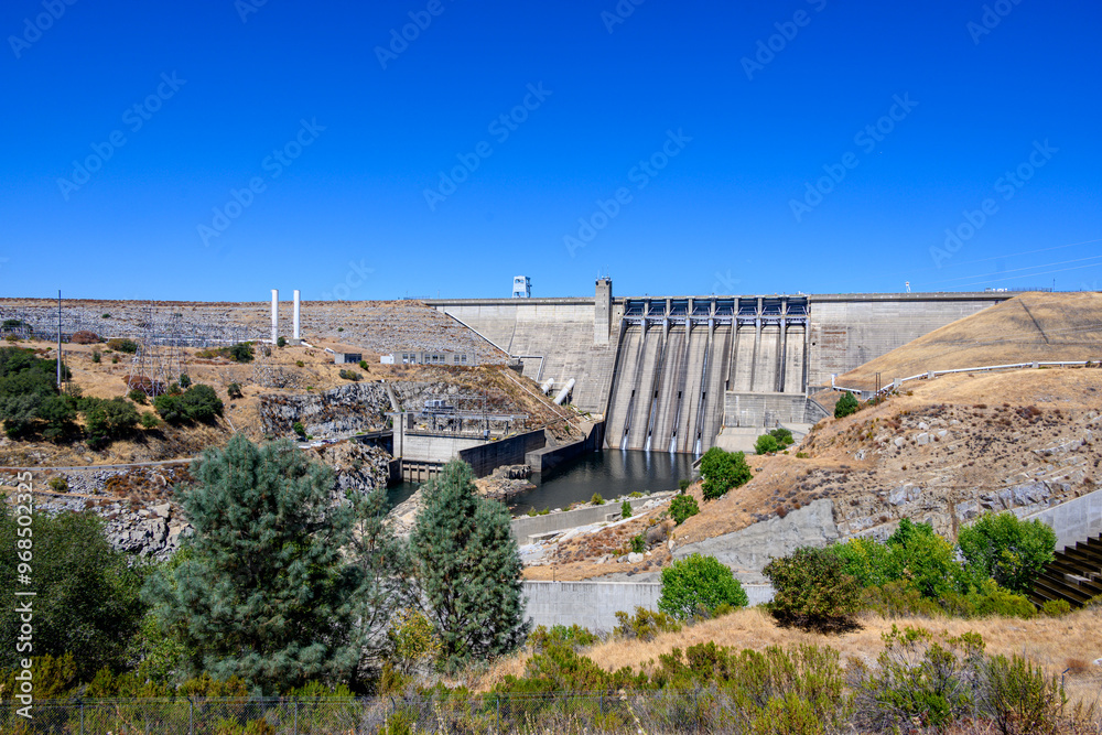 Folsom Dam with trees in foreground Folsom Dam with trees in foreground