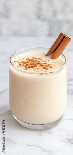 Delicious creamy beverage topped with a sprinkle of cinnamon, perfect for cozy gatherings and festive celebrations.