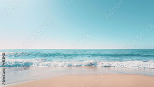 Calm beach shore with gentle waves and clear blue sky