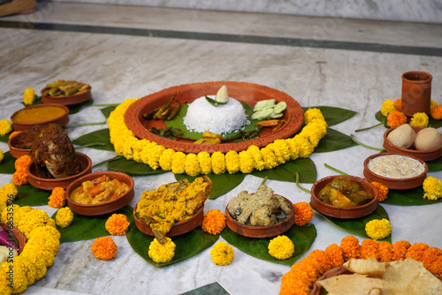 Different types of bengali dishes served in earthenware photo