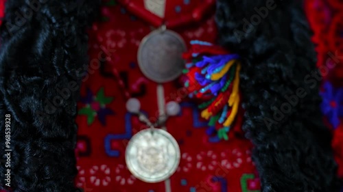 A close-up of traditional Romanian clothing featuring intricate embroidery, predominant red, vibrant colors, and unique patterns. photo