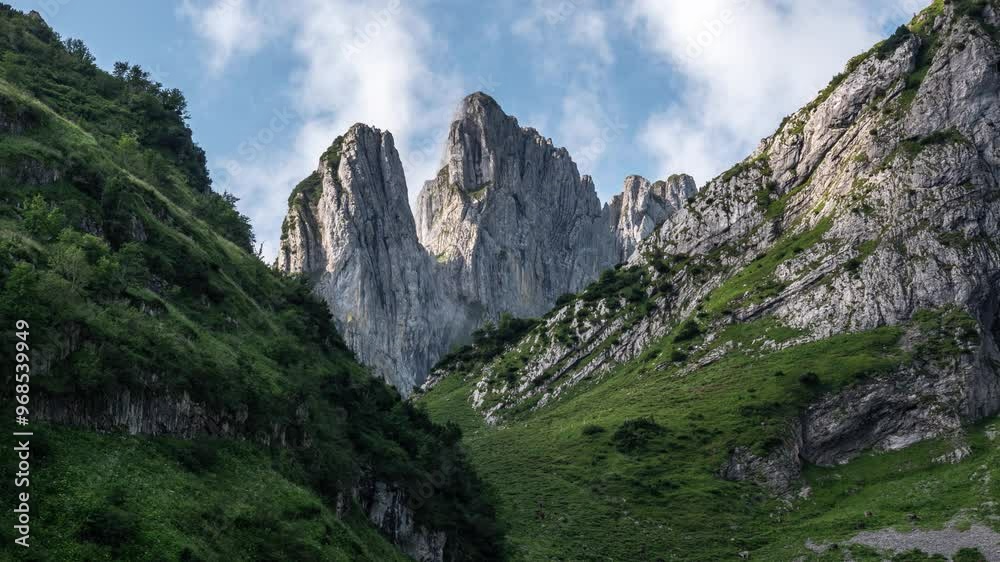 Timelapse of the Saxerlücke mountain pass in Alpstein. Green slopes and rocky terrain. In the distance, the dramatic peaks of the Chrüzberg rise through the mist Timelapse of the Saxerlücke mountain pass in Alpstein. Green slopes and rocky terrain. In the distance, the dramatic peaks of the Chrüzberg rise through the mist