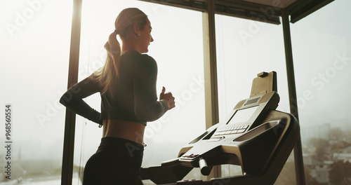 Woman, active and running on treadmill at gym for cardio exercise, workout and training performance. Fitness, female person and machine for morning routine, endurance or speed challenge of resilience photo