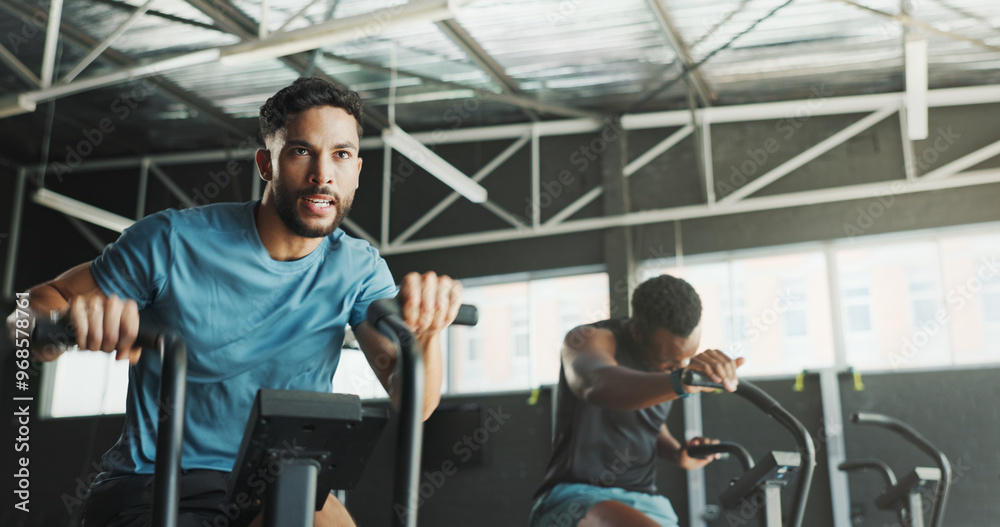 Man, fitness and strength on stationary bike at gym for exercise, training and workout with sweat. Cycling machine, energy and building muscles with cardio for health, self care and wellbeing Man, fitness and strength on stationary bike at gym for exercise, training and workout with sweat. Cycling machine, energy and building muscles with cardio for health, self care and wellbeing