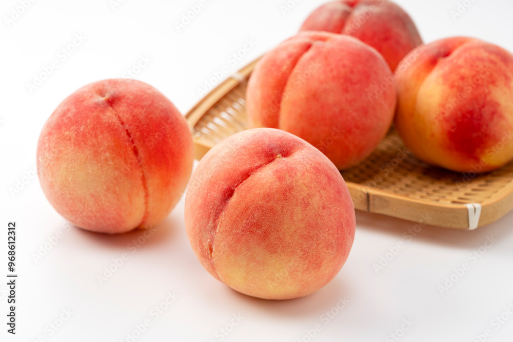 Peaches arranged in a colander on a white background. Peaches arranged in a colander on a white background.