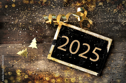 golden 2024 written on  little board on rustic wooden background illuminated ...