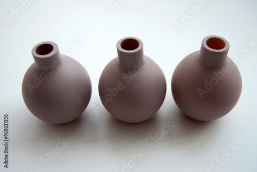 jugs isolated on white. Brown little vases still life. Three beige empty vases close-up. photo