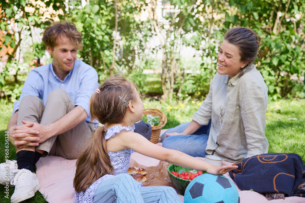 Happy parents and daughter enjoying weekend at back yard Happy parents and daughter enjoying weekend at back yard