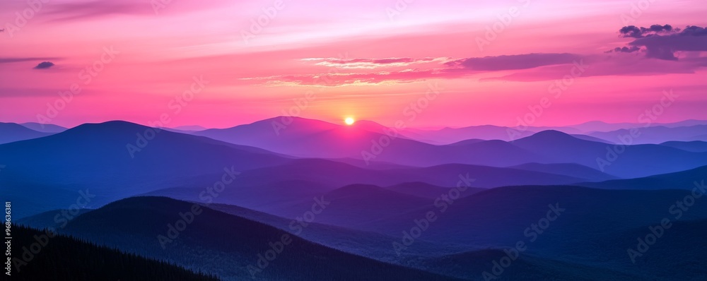 Sunset over mountain range with pink and