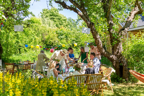 Friends with children having garden party