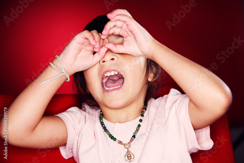 Girl with mouth open covering eyes photo