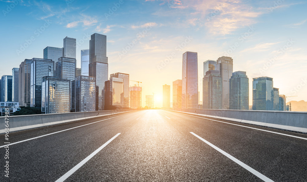 Asphalt highway road and modern city commercial buildings scenery at sunrise in Chongqing. Car background.