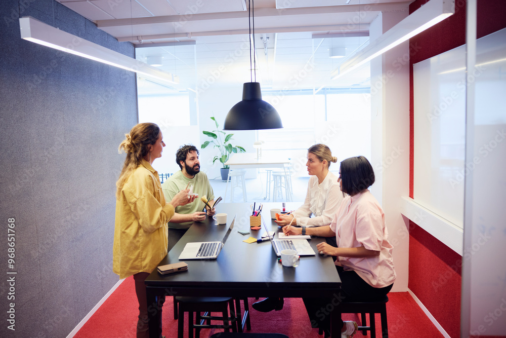 Multiracial corporate colleagues discussing during meeting in office Multiracial corporate colleagues discussing during meeting in office