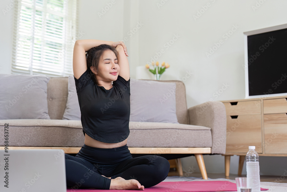 Woman doing yoga stretches at home in living room Woman doing yoga stretches at home in living room