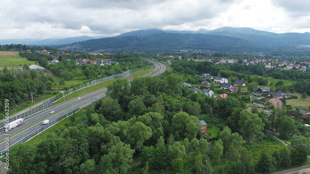 Winding road through green landscape with fields and houses Winding road through green landscape with fields and houses