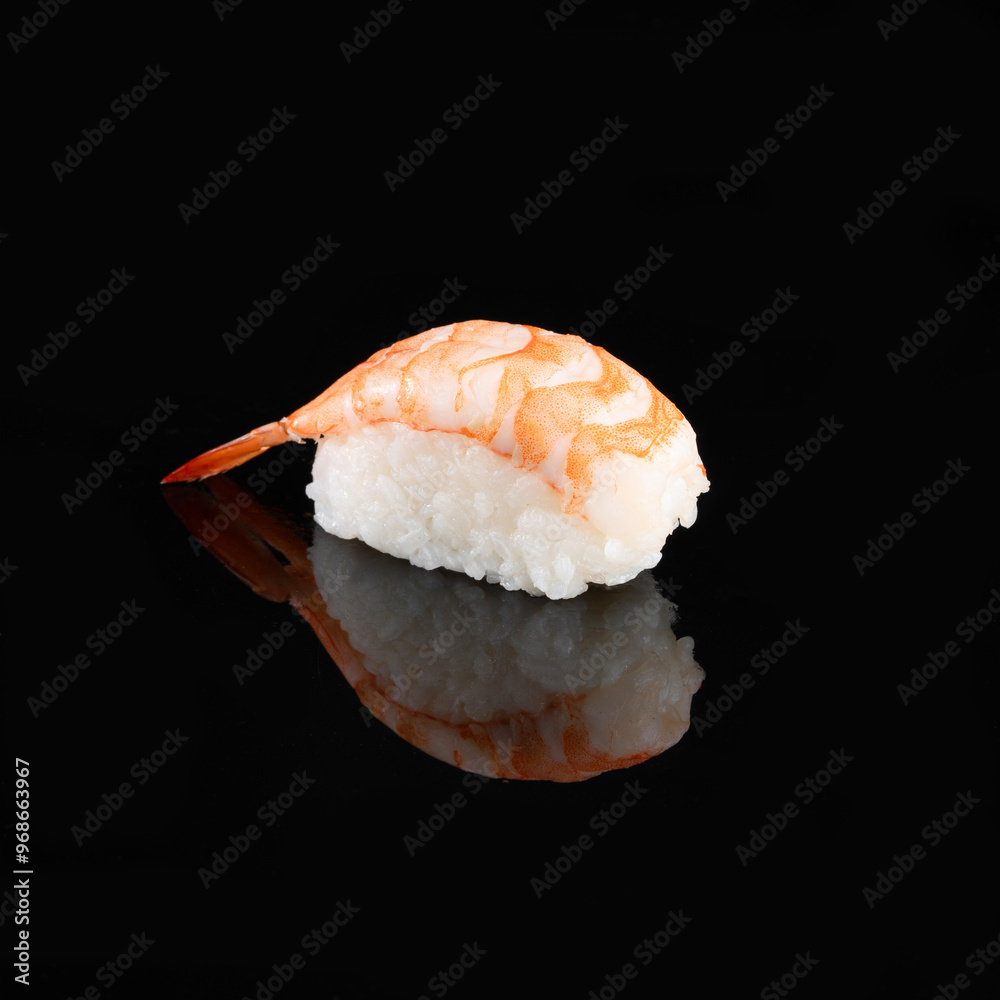 Close-up of a single shrimp sushi on a black reflective surface. Perfect for culinary, seafood, and Japanese cuisine themes. Close-up of a single shrimp sushi on a black reflective surface. Perfect for culinary, seafood, and Japanese cuisine themes.