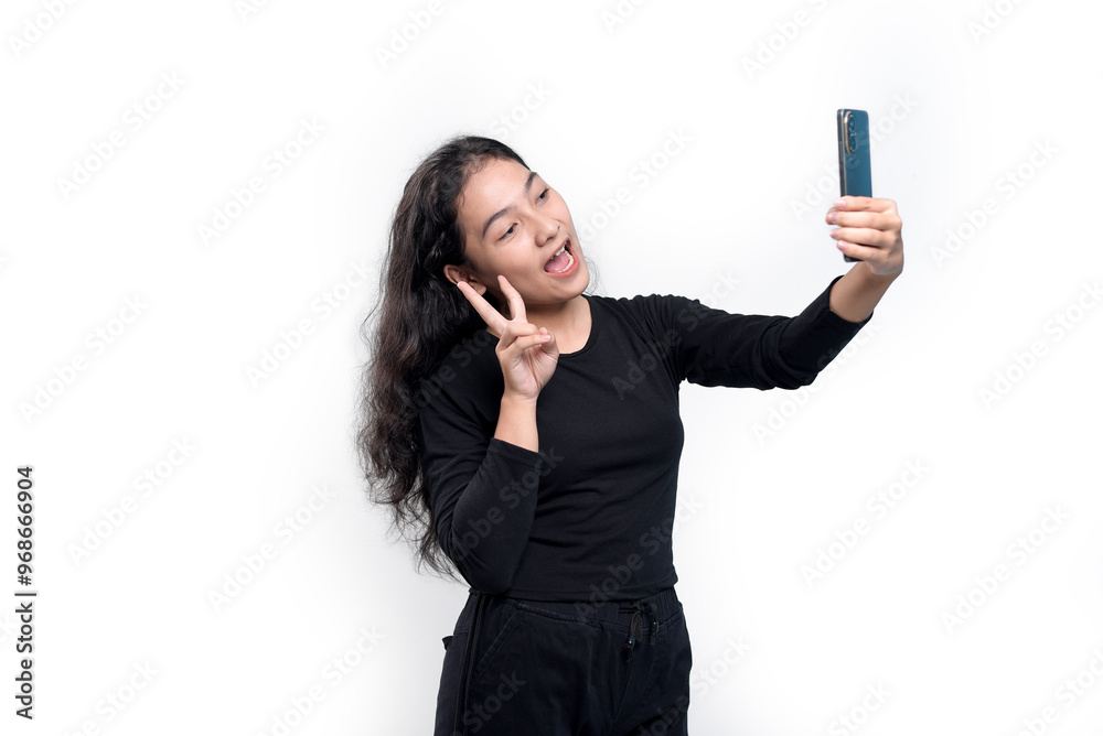 Smiling Asian woman in black t-shirt doing video call pose while waving palm saying hi isolated over white background. Smiling Asian woman in black t-shirt doing video call pose while waving palm saying hi isolated over white background.