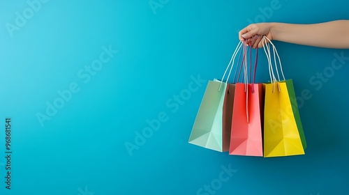 Women holding shopping bags, on blue background