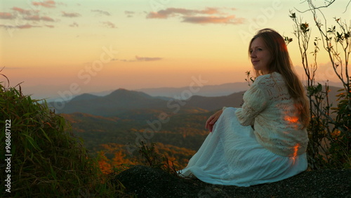 Wallpaper Mural Woman Sitting on Rock Overlooking Scenic Mountain Landscape at Sunset, Tranquility and Nature Appreciation. Torontodigital.ca