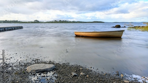 Obraz na płótnie Beautiful lakeside landscape scenery, old wooden fishing boat by Oughterard pier on Corrib lake, Galway, Ireland, nature background w salonie