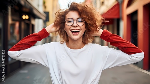 Portrait of a joyful woman laughing against a background.