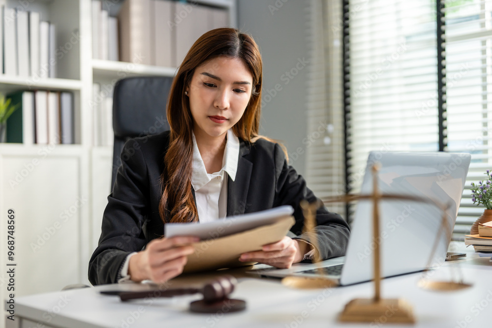 Asian lawyer woman work with hammer and scales of justice in courtroom. Asian lawyer woman work with hammer and scales of justice in courtroom.