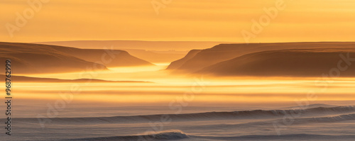 A beautiful sunset over the ocean, with the water and sky blending together in a warm, orange glow. The waves are crashing against the shore, creating a peaceful and serene atmosphere