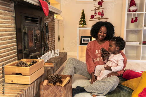 Family Sharing a Special Christmas Moment by Fireplace photo