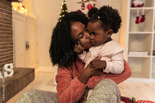 Tender Christmas Kiss between Mother and Child photo