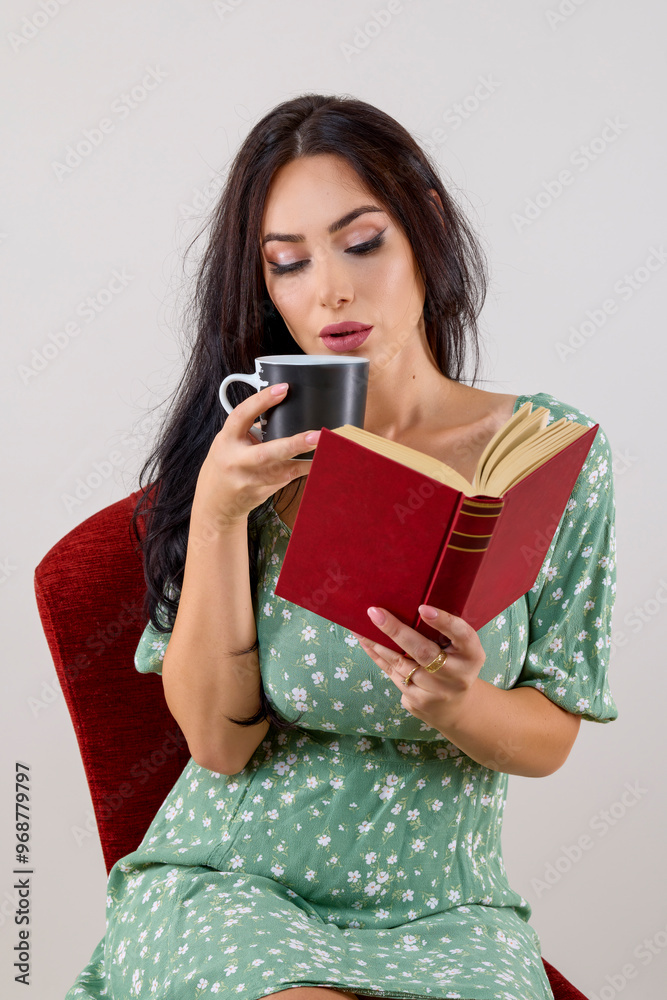 portrait of a beautiful woman with long hair holding a mug and reading a book. portrait of a beautiful woman with long hair holding a mug and reading a book.