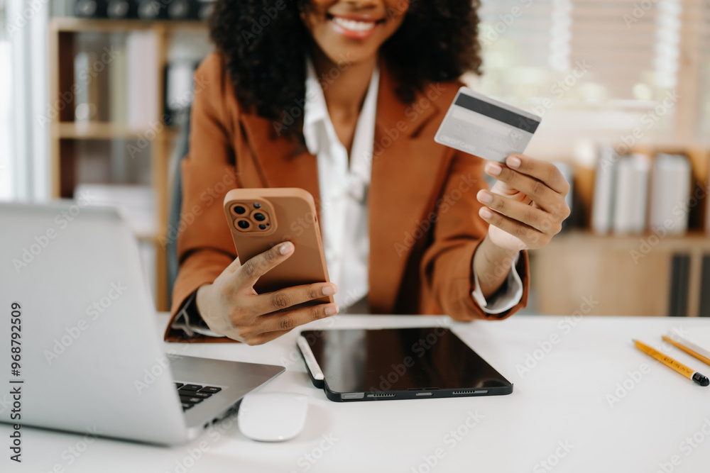 © Nuttapong punna - Woman using smart phone for mobile payments online shopping, omni channel, sitting on table