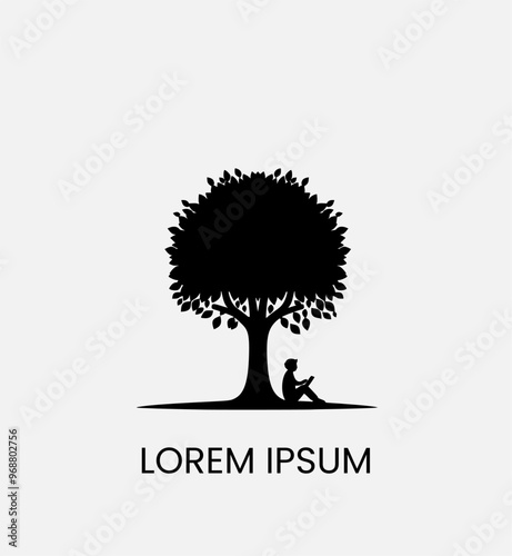 silhouette of a person sitting under a tree while reading a book