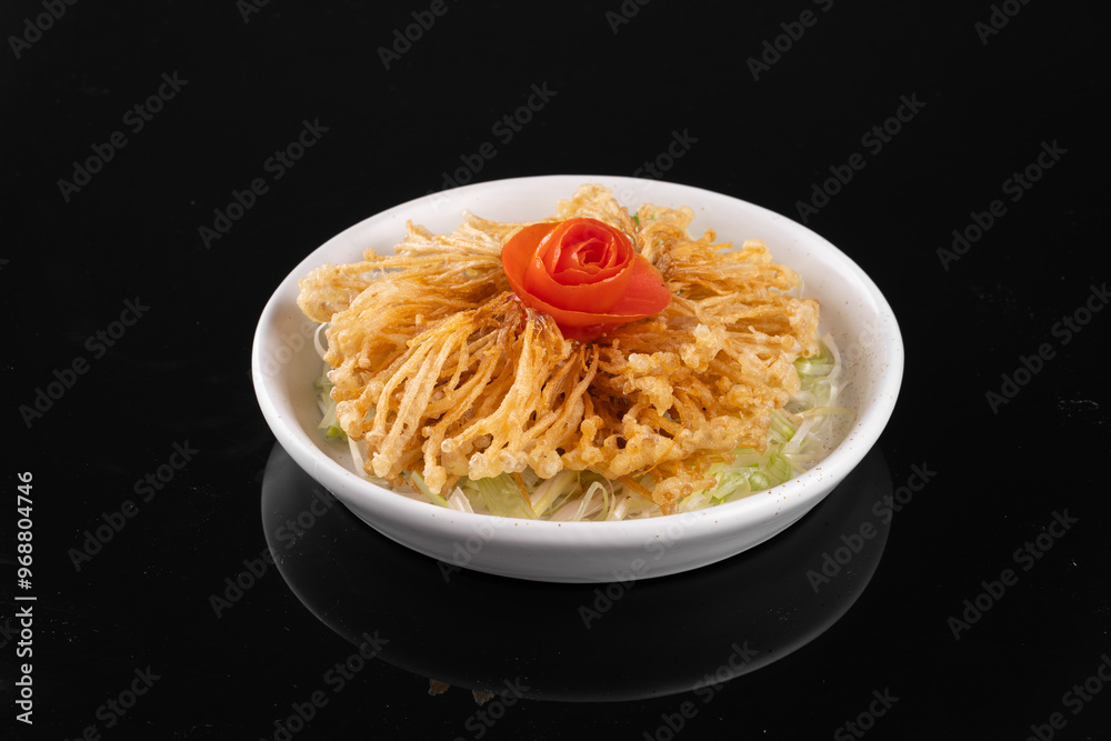 Gourmet Asian dish with crispy fried onions and a delicate vegetable garnish served in a white bowl on a black background. Gourmet Asian dish with crispy fried onions and a delicate vegetable garnish served in a white bowl on a black background.