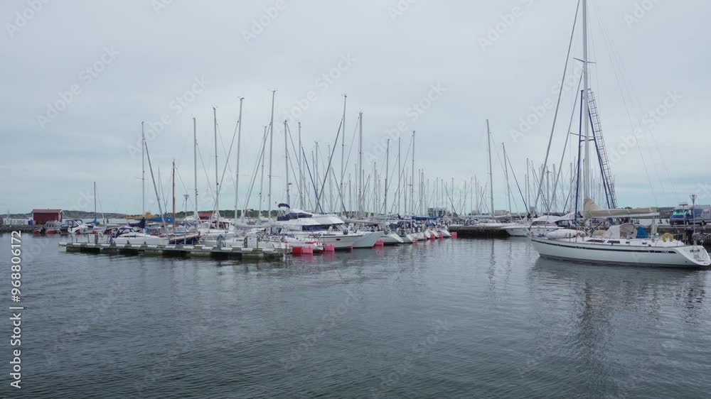 Wide shot of multiple sailboats and boats at an smaller harbour. Wide shot of multiple sailboats and boats at an smaller harbour.