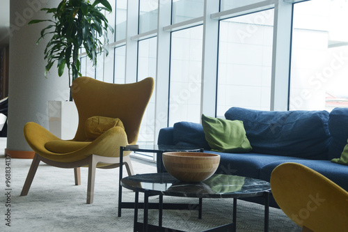 Relaxation area in the lobby of a luxury hotel - armchairs and a sofa, a coffee table. Modern interiors.