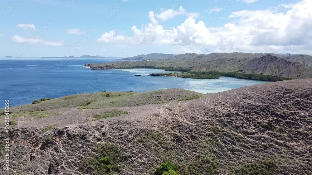 Flying over a hill above open ocean in Indonesia Flying over a hill above open ocean in Indonesia