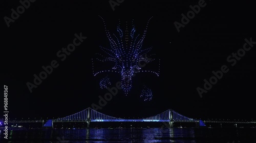 Glowing Flying Drones Hive Froming 3d Dragon Head in Night Sky.
Gwangalli Beach Drone Light Show Above Gwangan Bridge in Busan, South Korea. photo