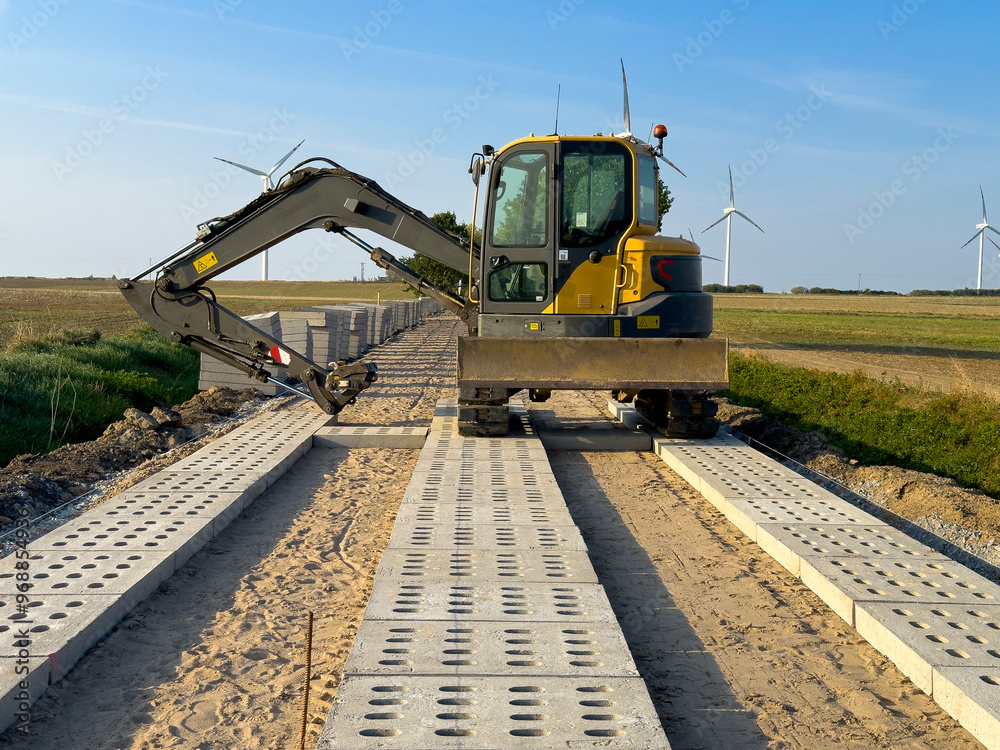 Process of making a new road with concrete slabs as a surface. Process of making a new road with concrete slabs as a surface.