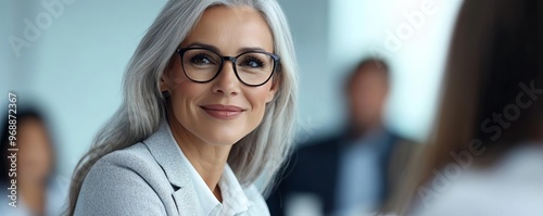 Mature woman attending a high-level negotiation, calm and composed under pressure