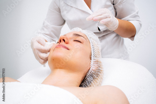 A young woman undergoing cutting-edge treatments at a sleek cosmetic center. Modern technologies for flawless care and rejuvenation. Perfect for promoting salon services and advanced skincare.