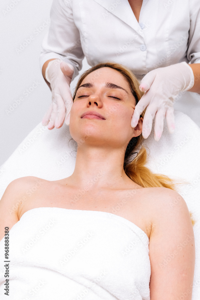 Luxurious spa setting: facial massage in a modern cosmetic clinic. Premium care for relaxation and rejuvenation. Ideal for promoting spa treatments and cosmetic services. Luxurious spa setting: facial massage in a modern cosmetic clinic. Premium care for relaxation and rejuvenation. Ideal for promoting spa treatments and cosmetic services.