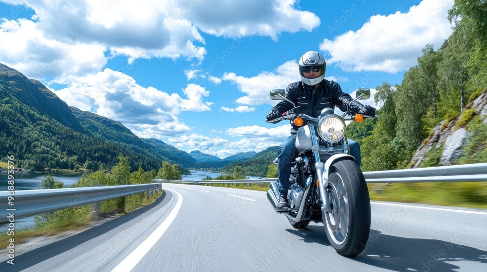 A motorcyclist in a black jacket and helmet rides a blue motorcycle on a scenic mountain road beside a serene lake, under a clear blue sky with scattered clouds. A motorcyclist in a black jacket and helmet rides a blue motorcycle on a scenic mountain road beside a serene lake, under a clear blue sky with scattered clouds.