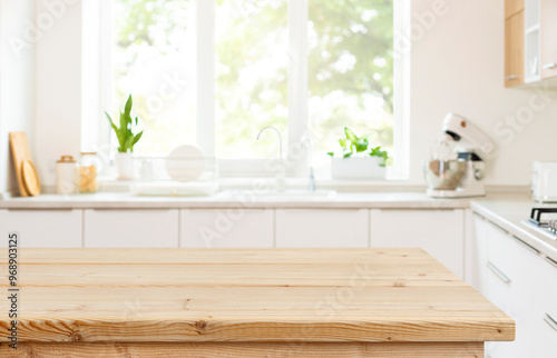 Empty wood table top view for product display montage on blur kitchen counter and wide window background