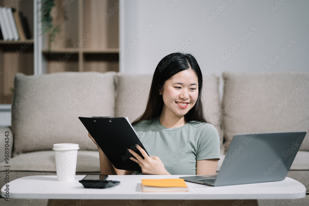 lifestyle of office workers Woman calculating expenses and using laptop. Home office. Work place. Lifestyle. lifestyle of office workers Woman calculating expenses and using laptop. Home office. Work place. Lifestyle.