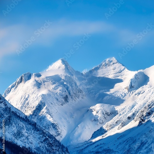 Majestic snow-capped mountain peaks under a clear blue sky in winter