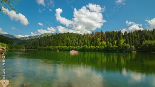 Karagol Lake in Savsat district of Artvin province in Turkey. Time lapse 4k video of a lake and motion of the clouds and boats. Visit Turkey concept video. photo